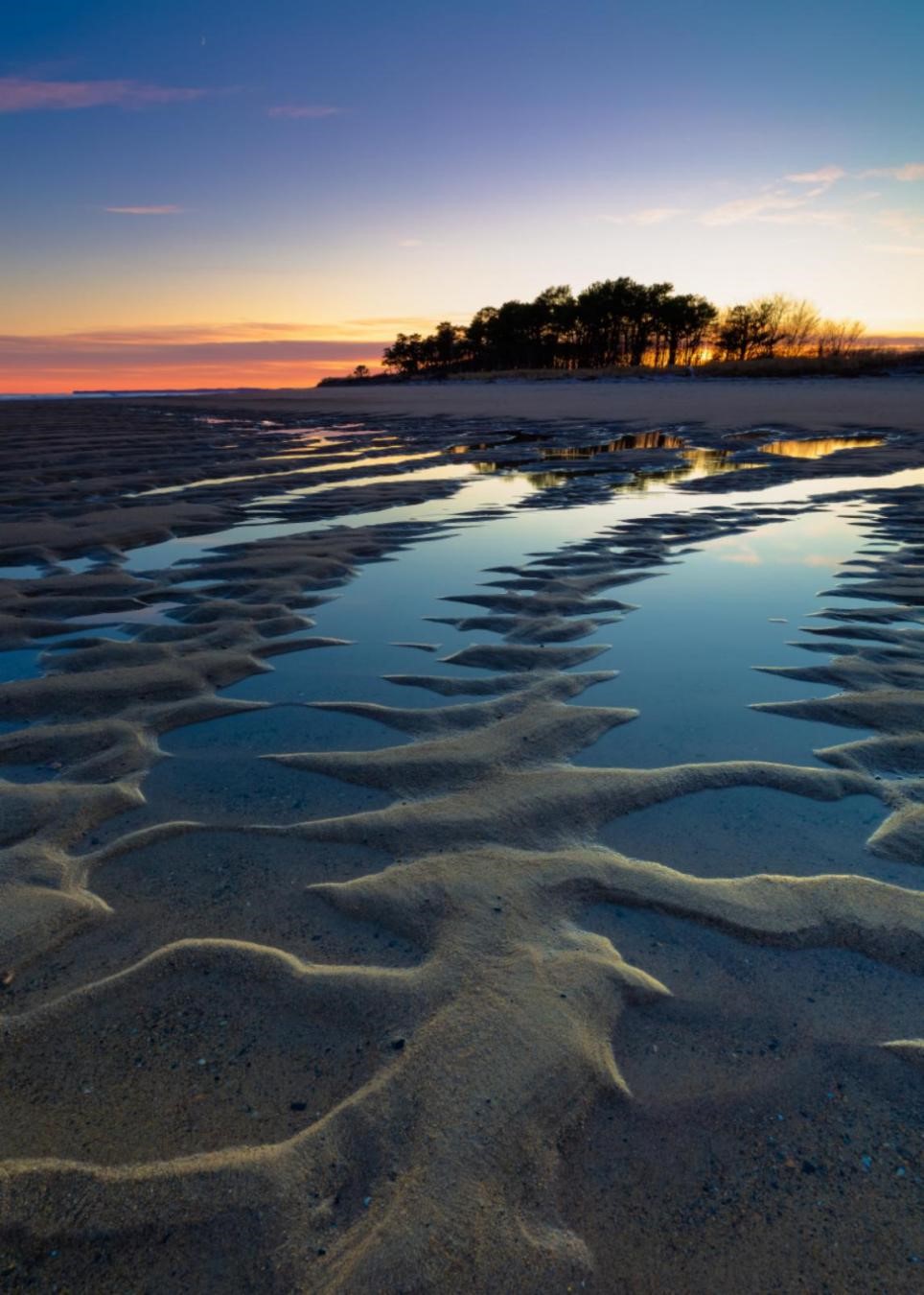 Image of a sunset on the beach at Wells Reserve, Maine