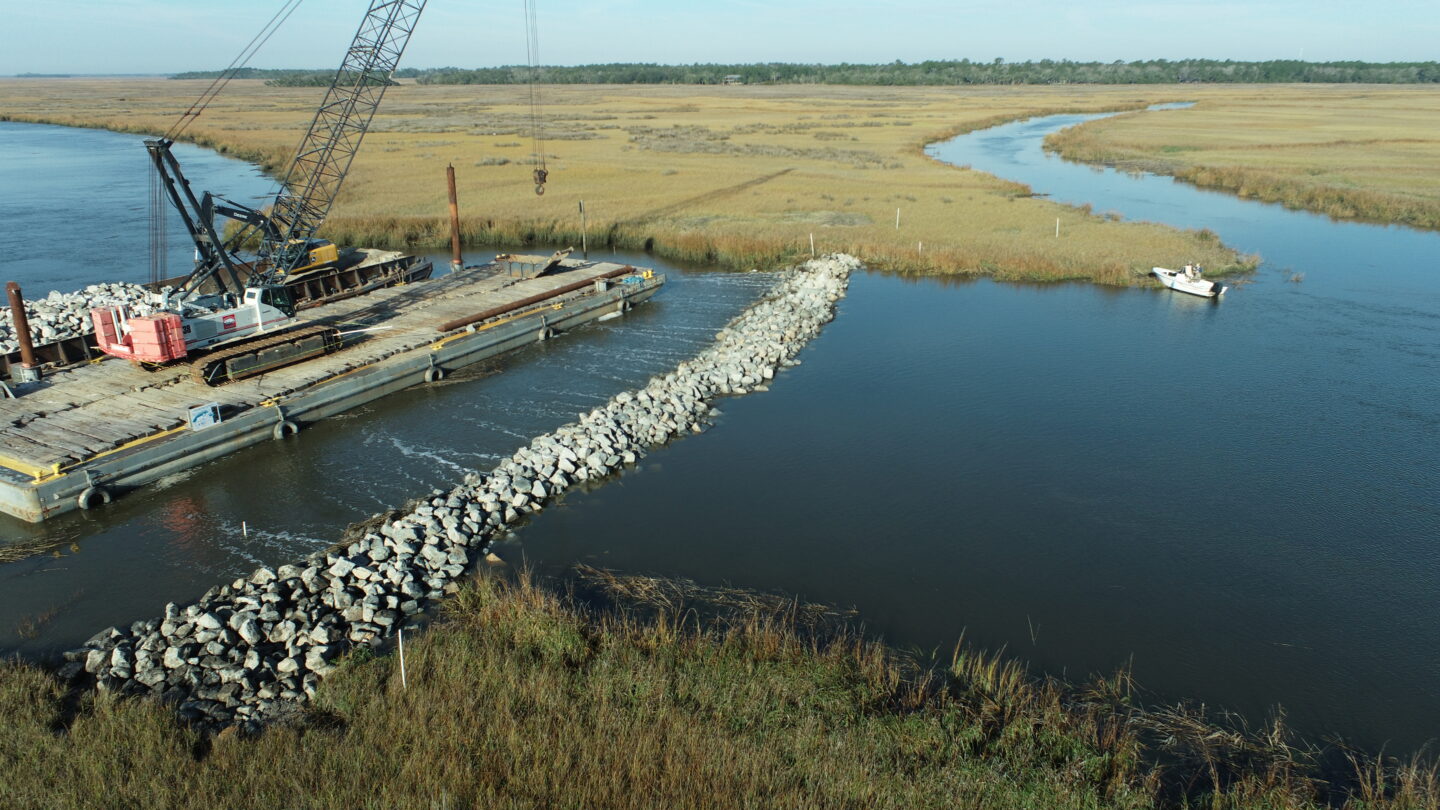 A salt marsh with a large platform and machinery