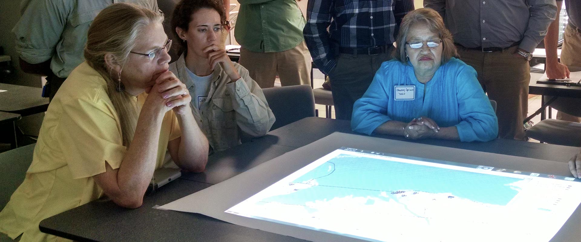 Training participants looking at a map